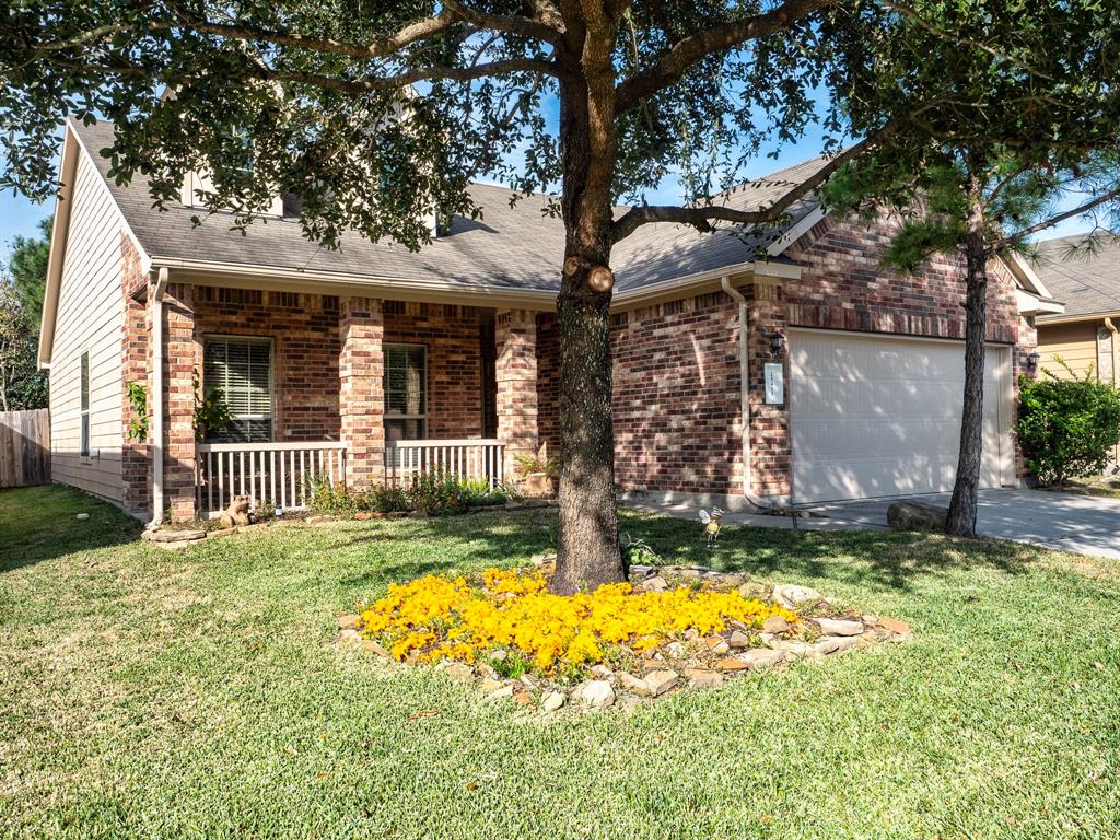 a view of a house with a yard and garage