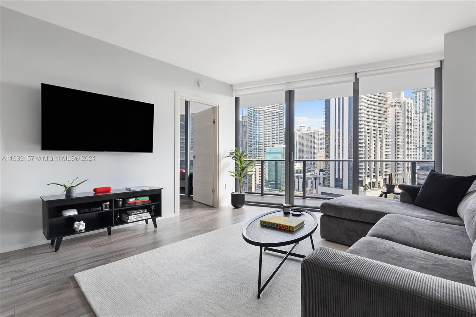 a living room with furniture and a flat screen tv