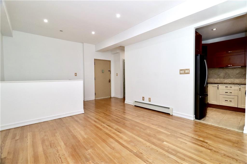 a view of a room with wooden floor