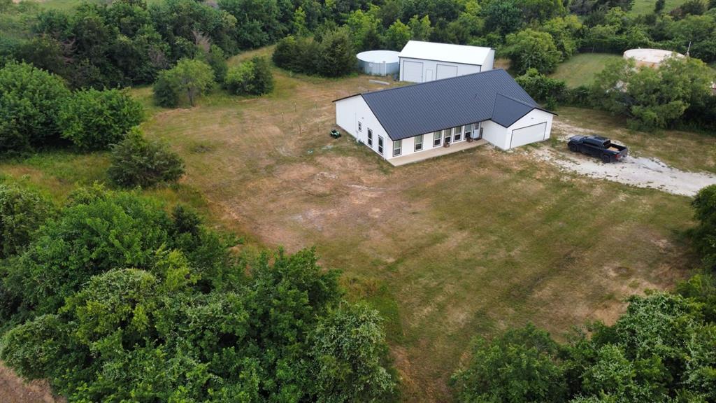 an aerial view of a house with garden space and street view