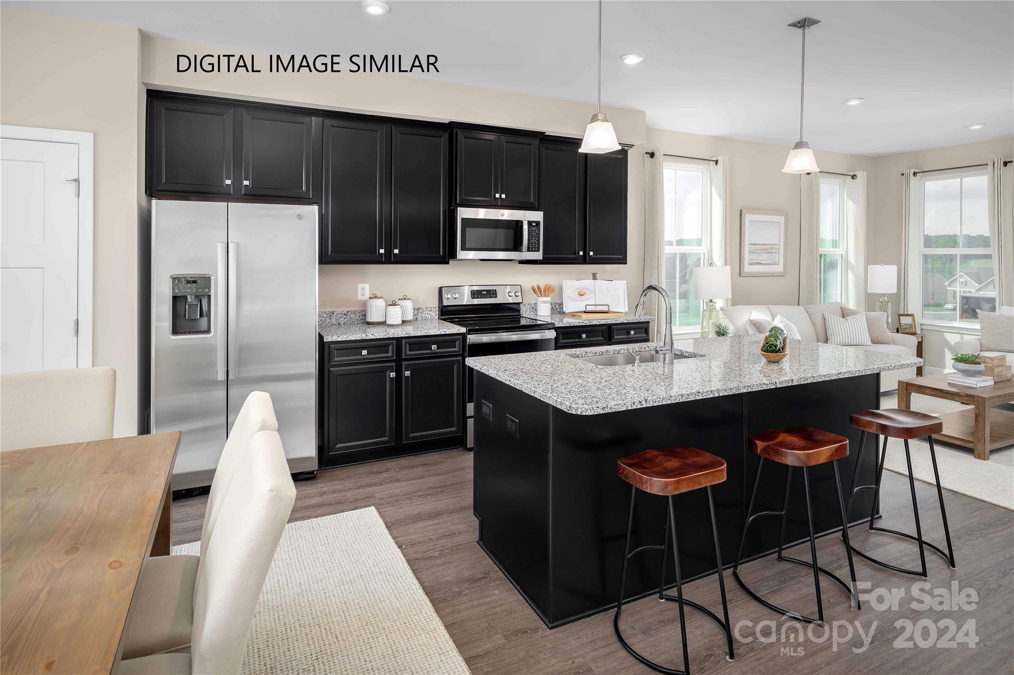 a kitchen with granite countertop a sink cabinets and stainless steel appliances