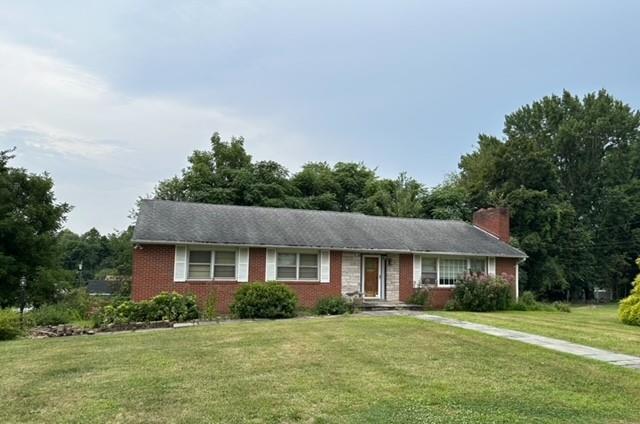 Ranch-style home with a front lawn