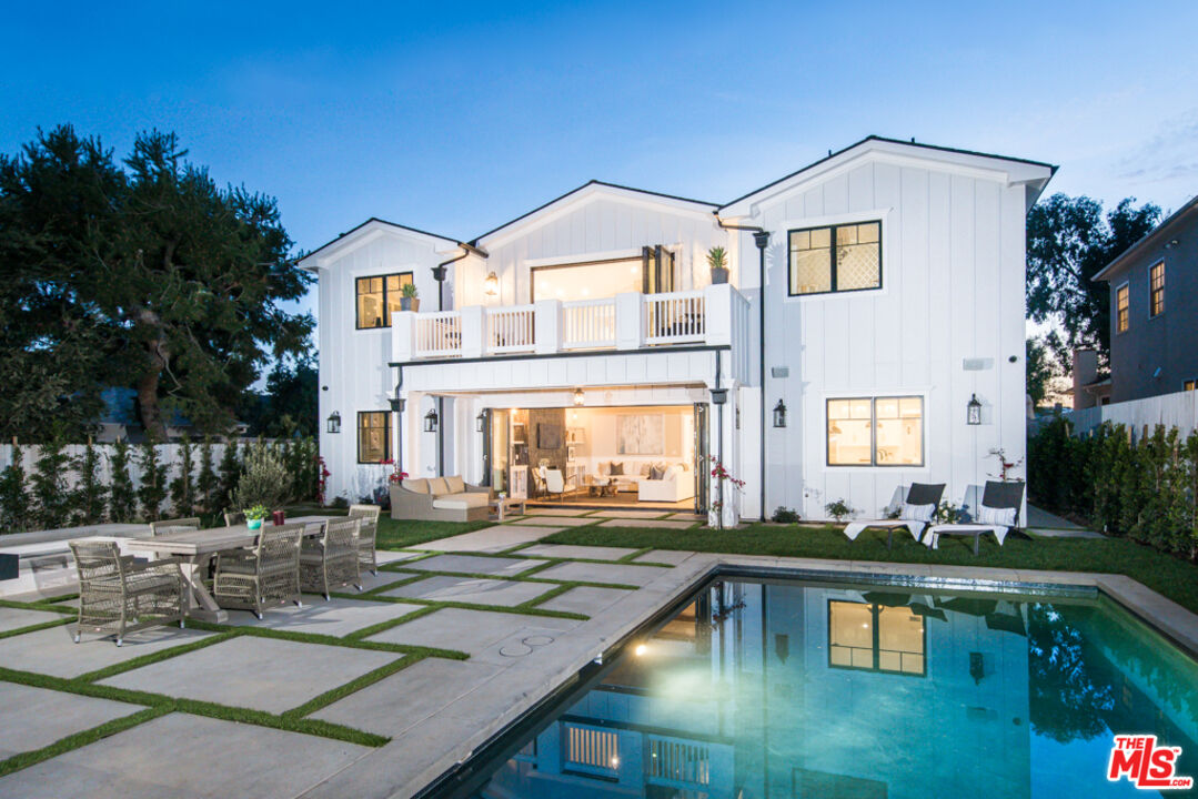 a front view of house with yard and outdoor seating