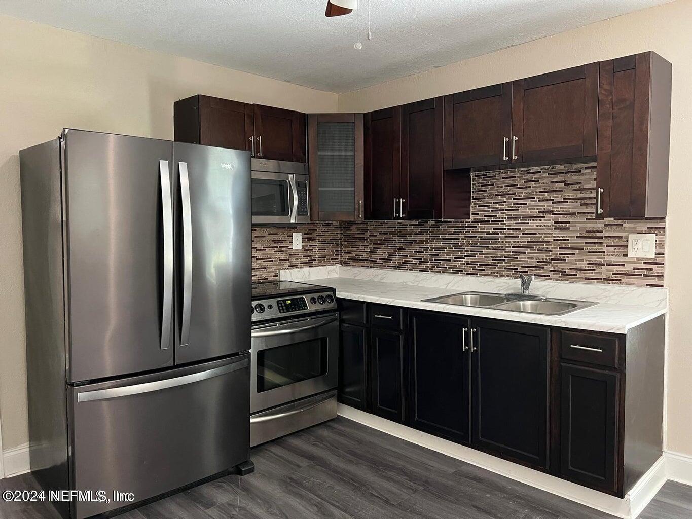 a kitchen with stainless steel appliances wooden cabinets and granite counter tops