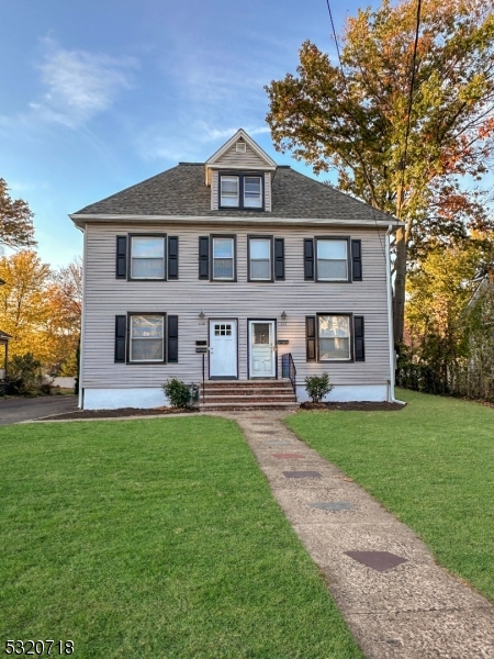 a front view of a house with a yard