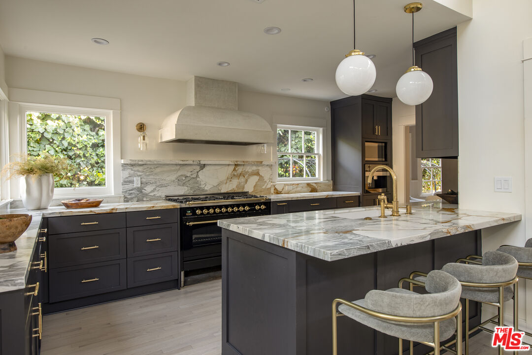 a kitchen with a stove a sink and a refrigerator