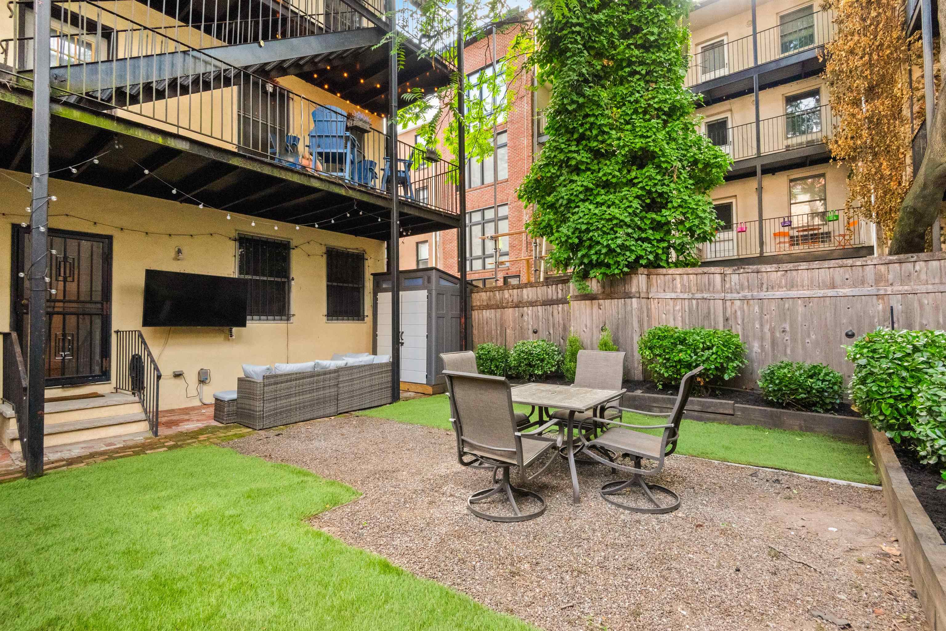 a view of a chair and table in backyard of the house