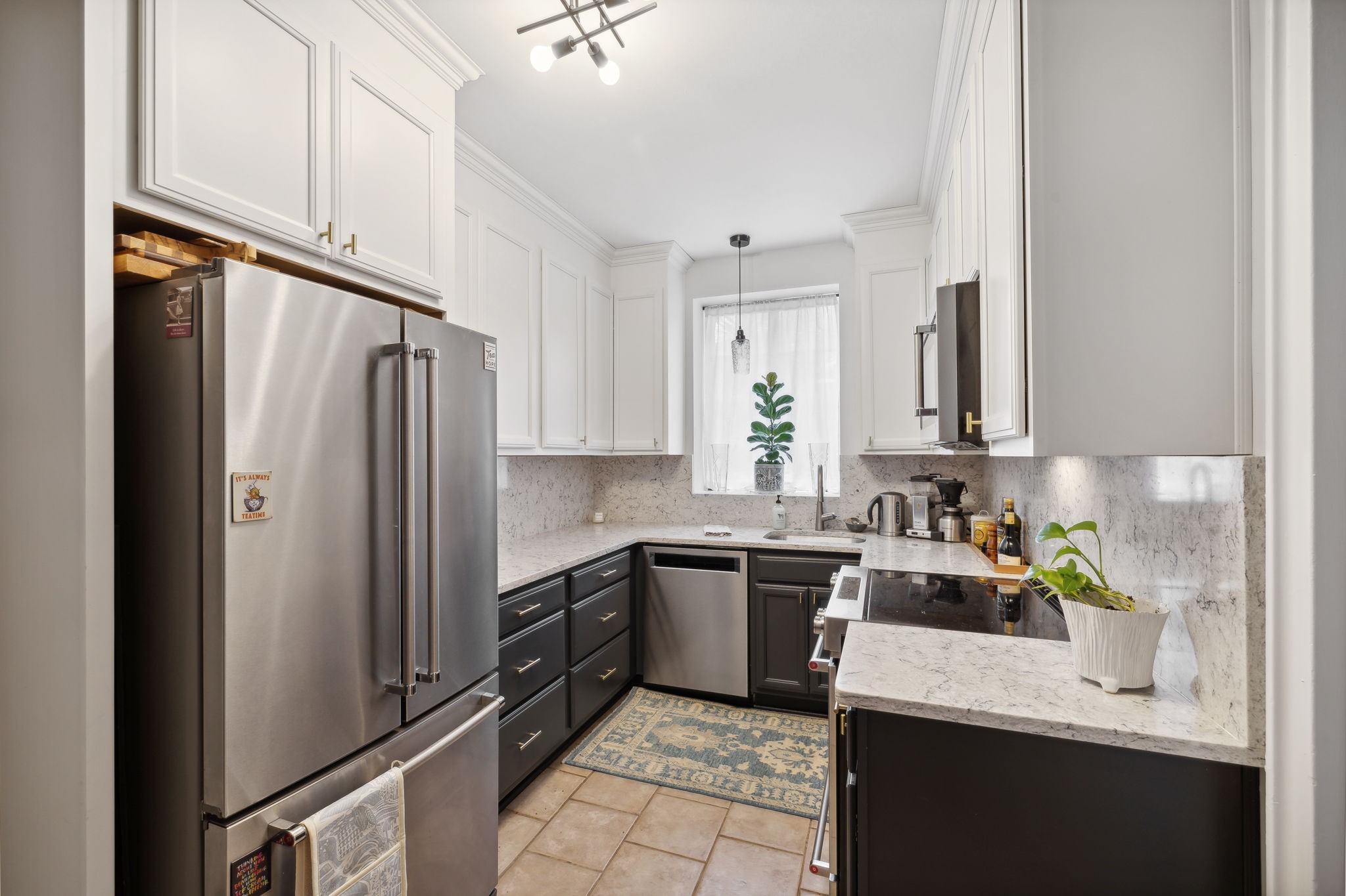 a kitchen with stainless steel appliances granite countertop a refrigerator sink and cabinets