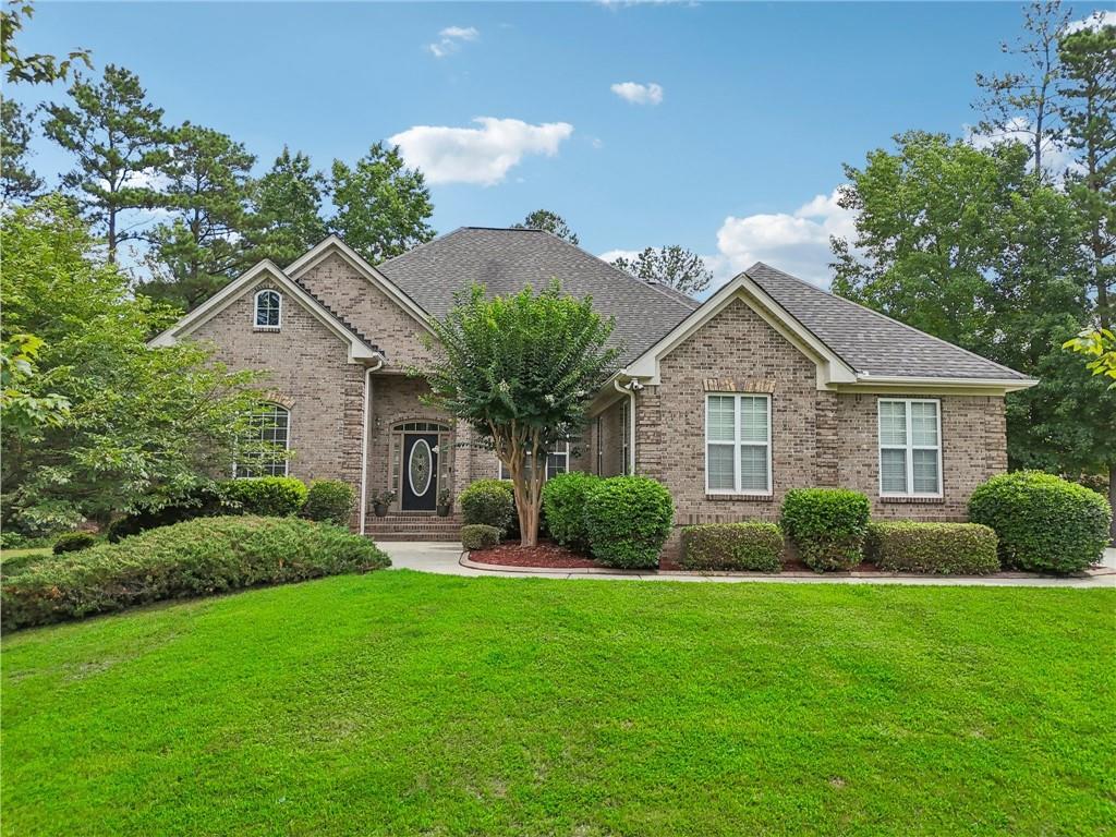 a front view of a house with a yard and outdoor seating