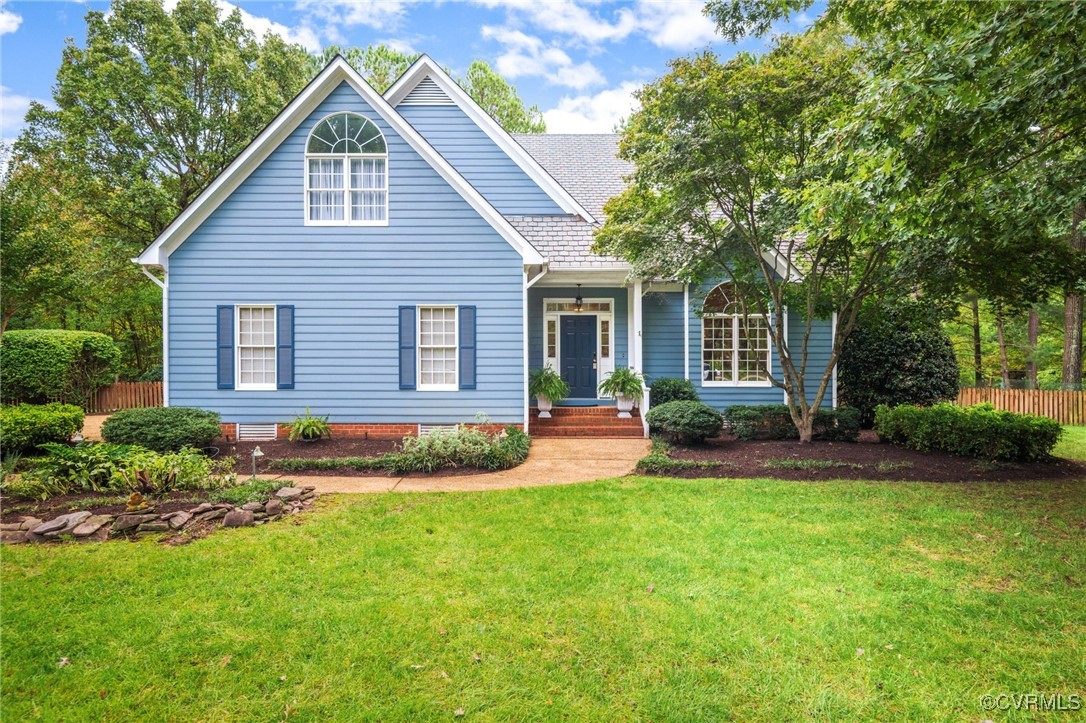 a view of a house with a patio and a yard