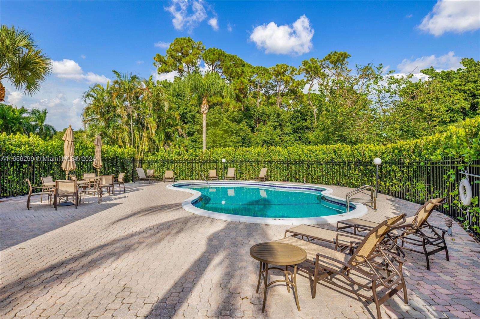 a view of a swimming pool with a patio and a yard