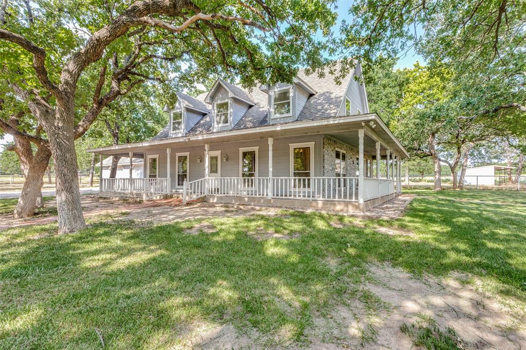 a view of a house with a backyard