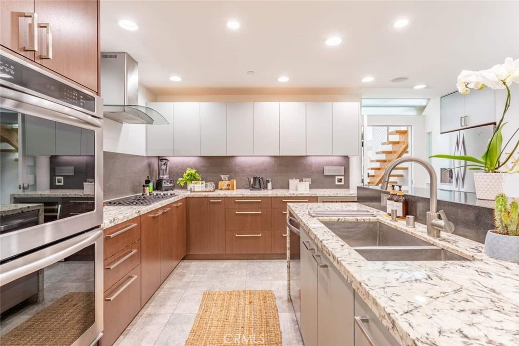 a kitchen with a sink stove and cabinets