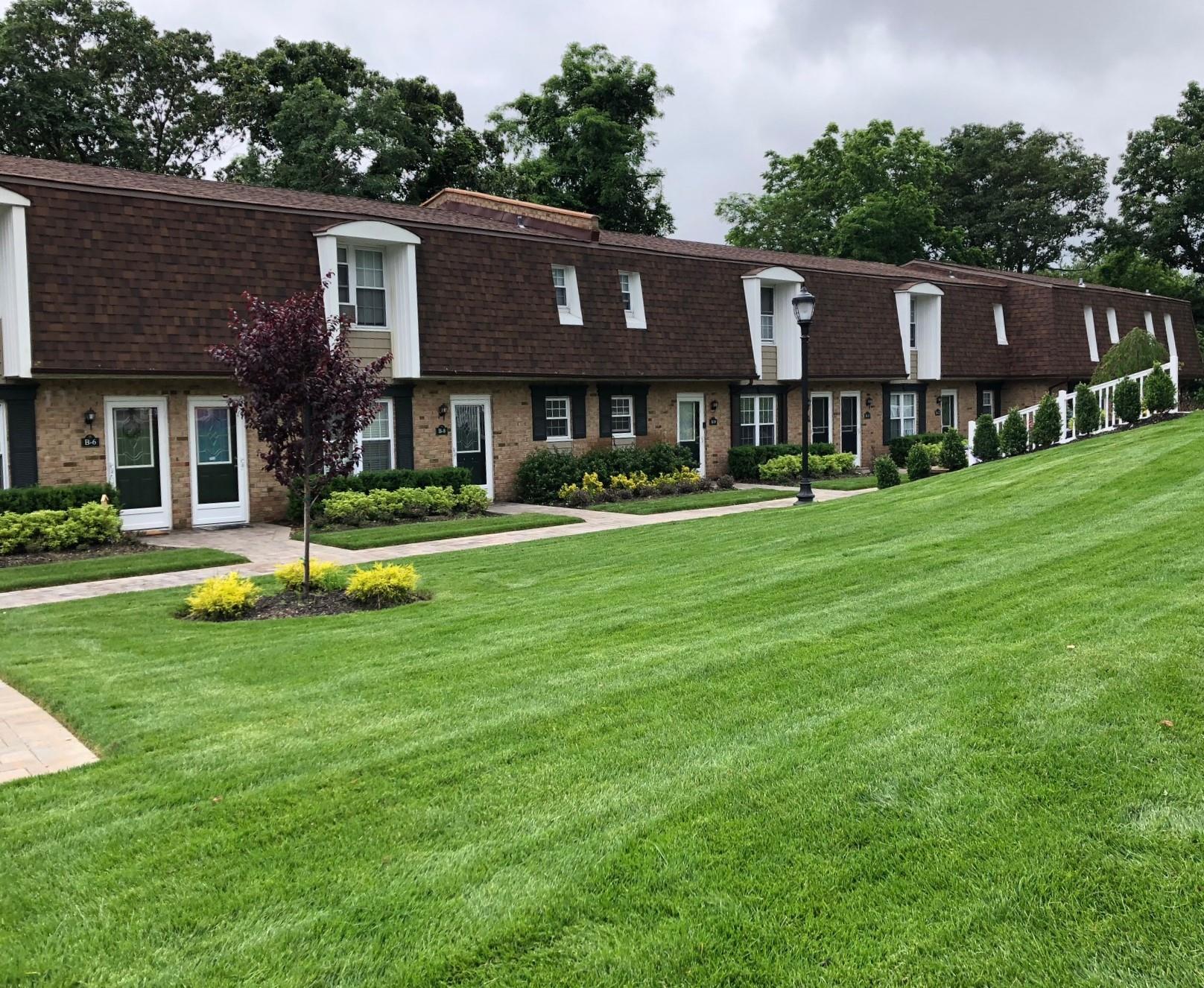 a view of a house with a yard and sitting area