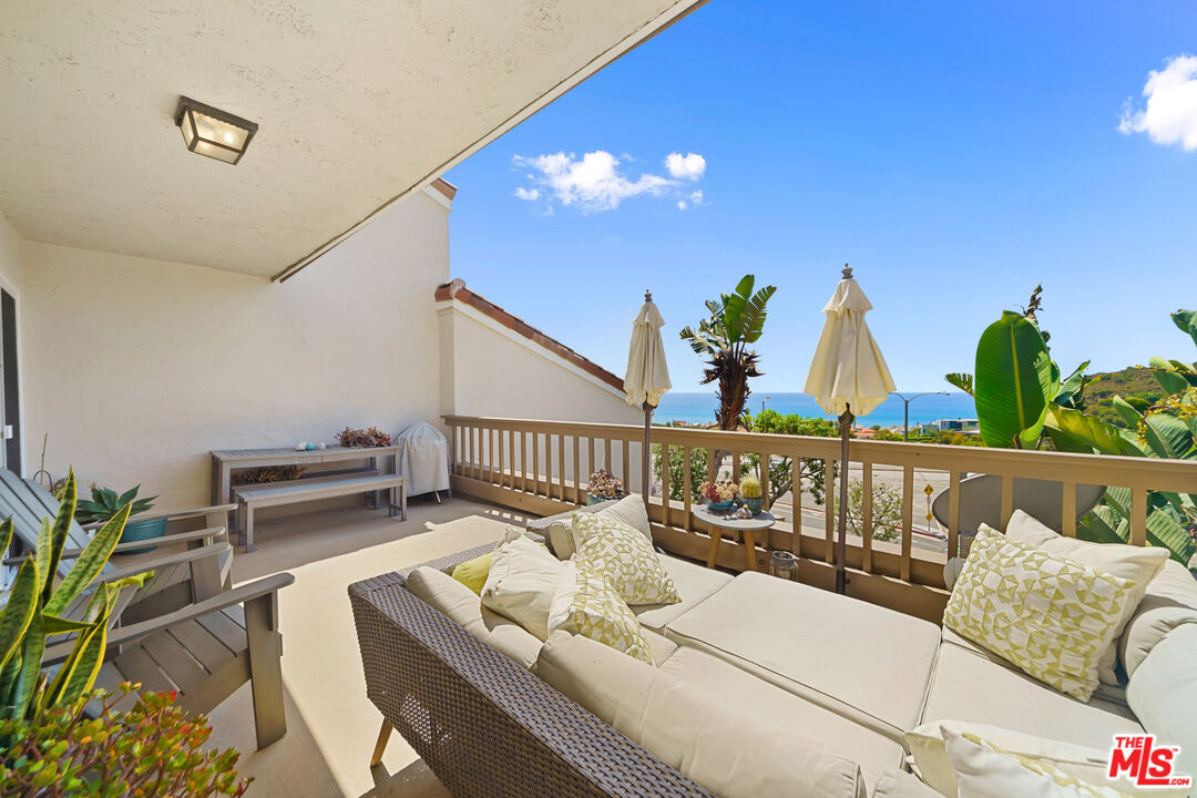 a view of a balcony with furniture