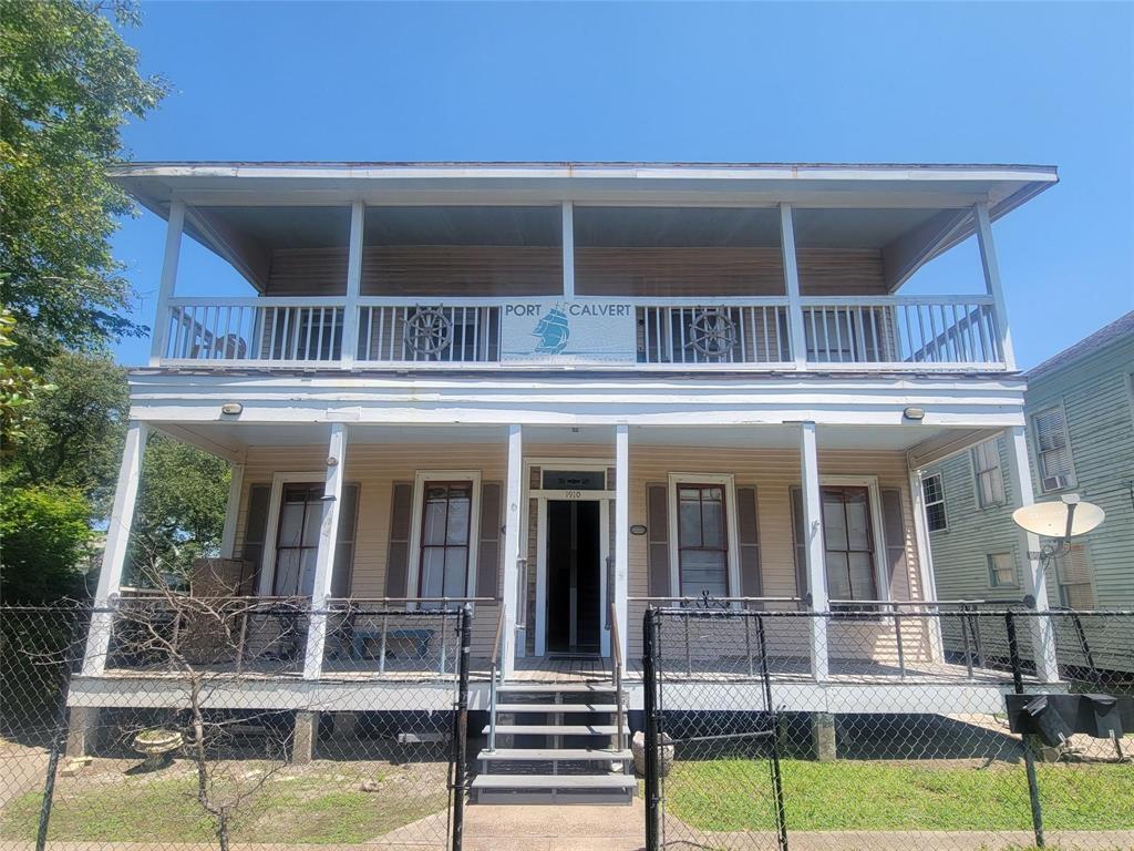 a view of house with swimming pool and porch