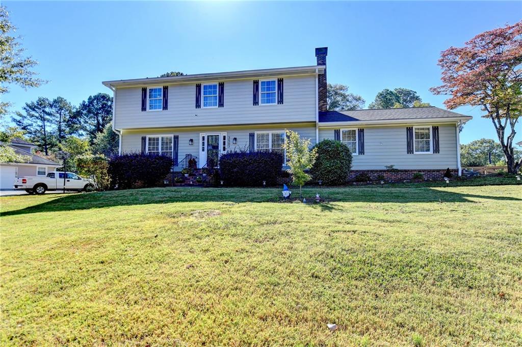 a view of a house with a yard and plants