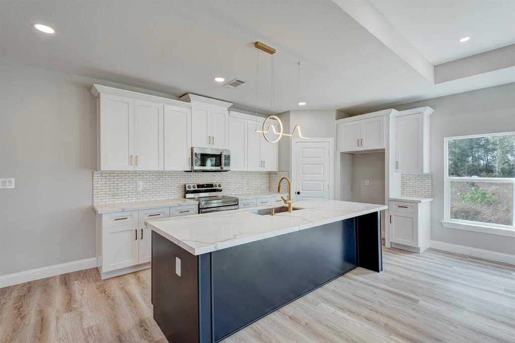 a kitchen with a sink stove and cabinets