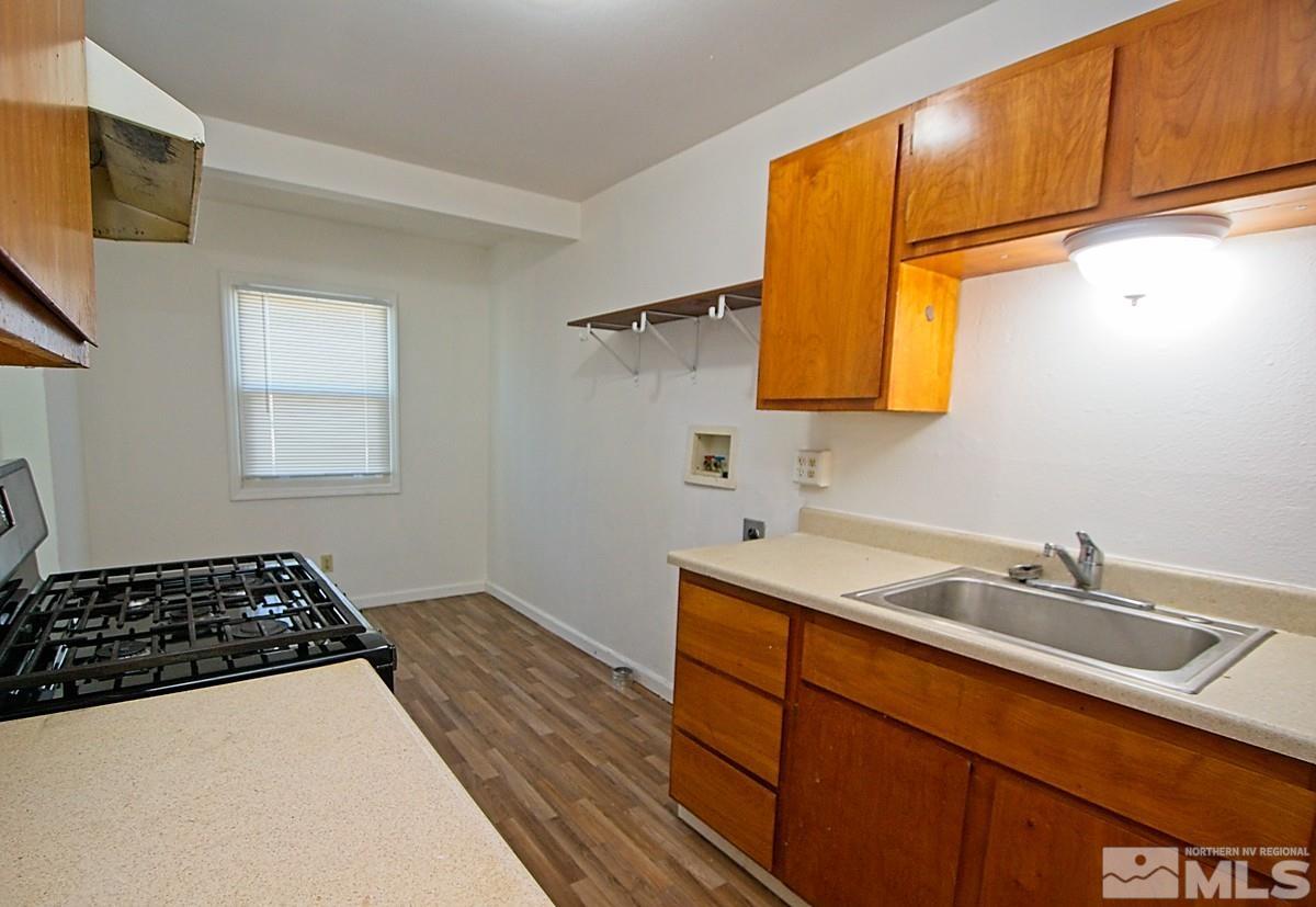 a kitchen with a sink and a stove top oven