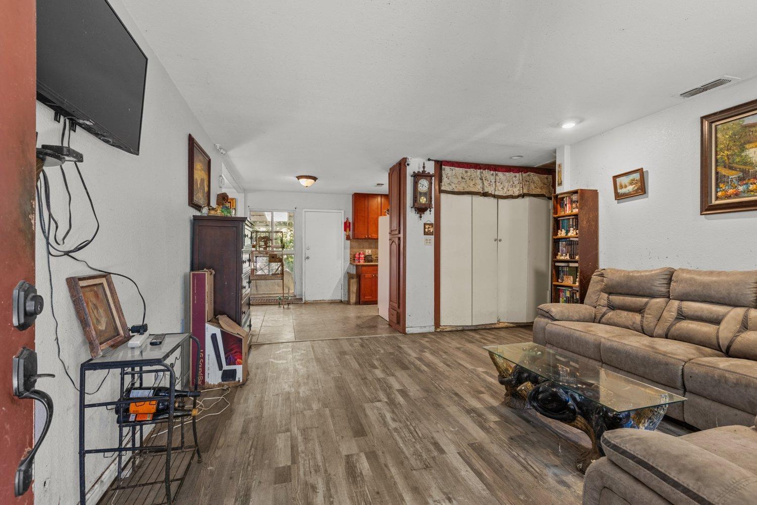 a living room with furniture a ceiling fan and a rug