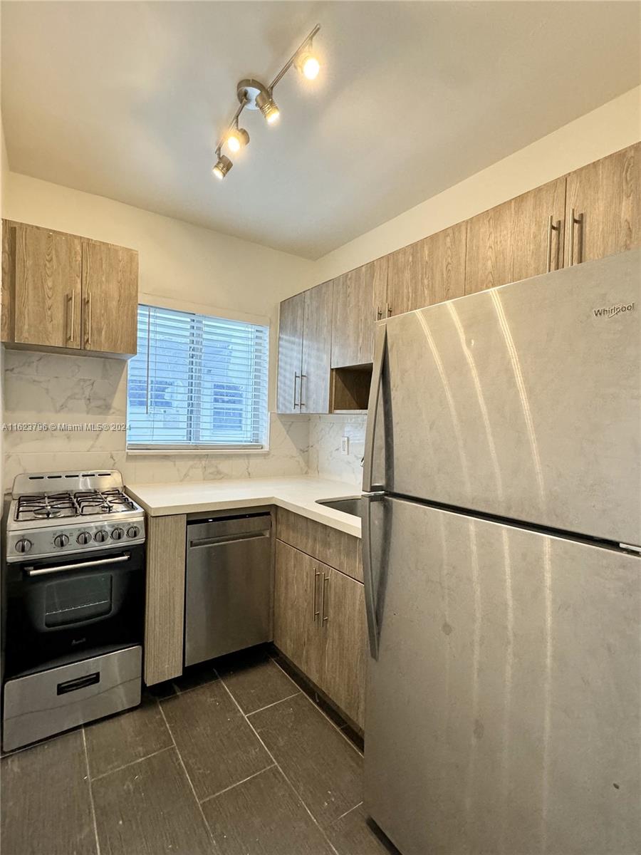 a kitchen with a white cabinets and white appliances