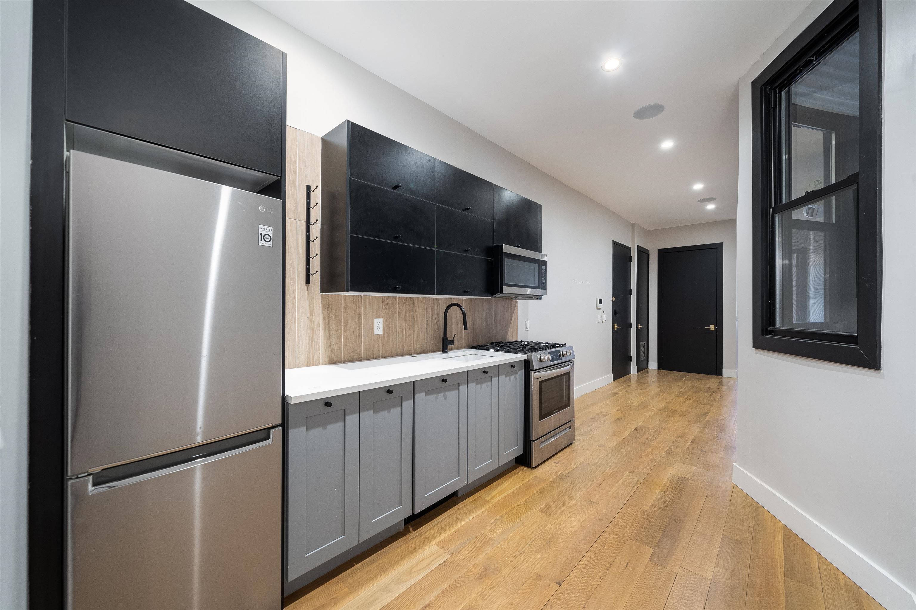 a kitchen with a refrigerator and a sink