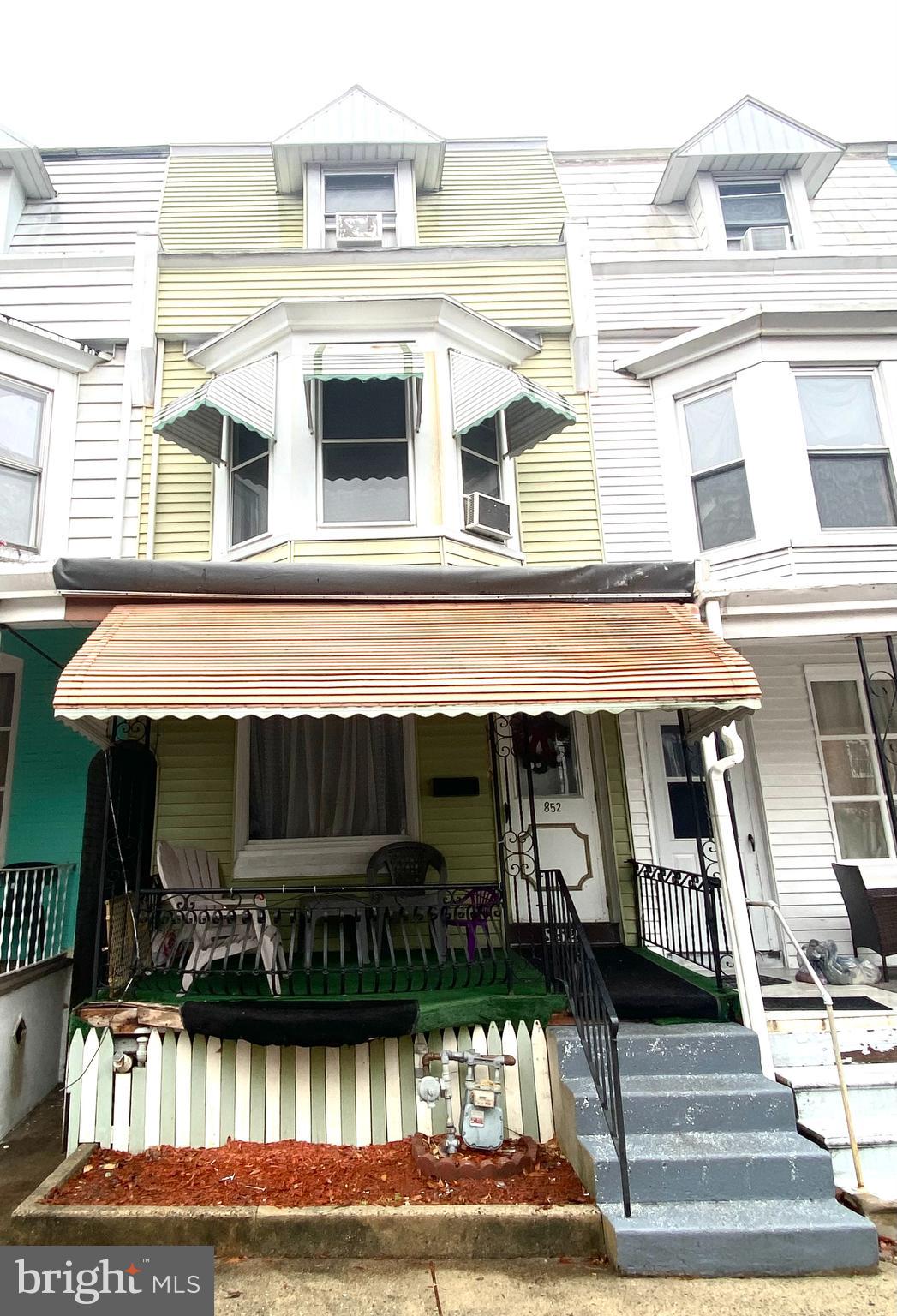 a front view of a residential apartment building with a yard