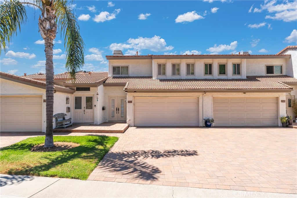 a view of a house with a yard and tree s