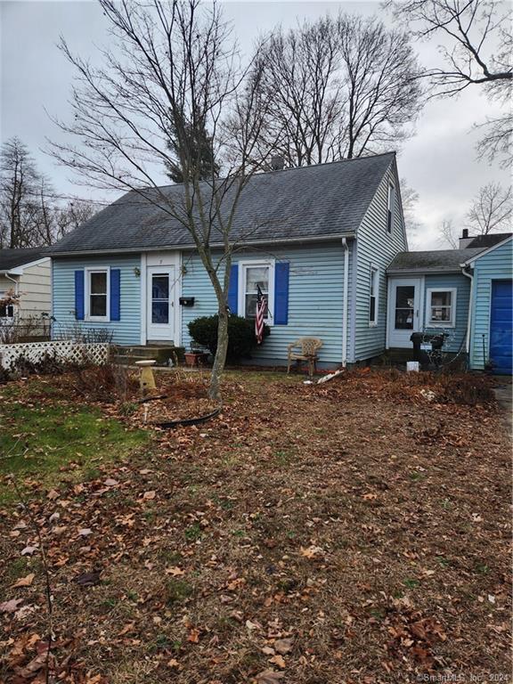 a front view of house with yard and trees