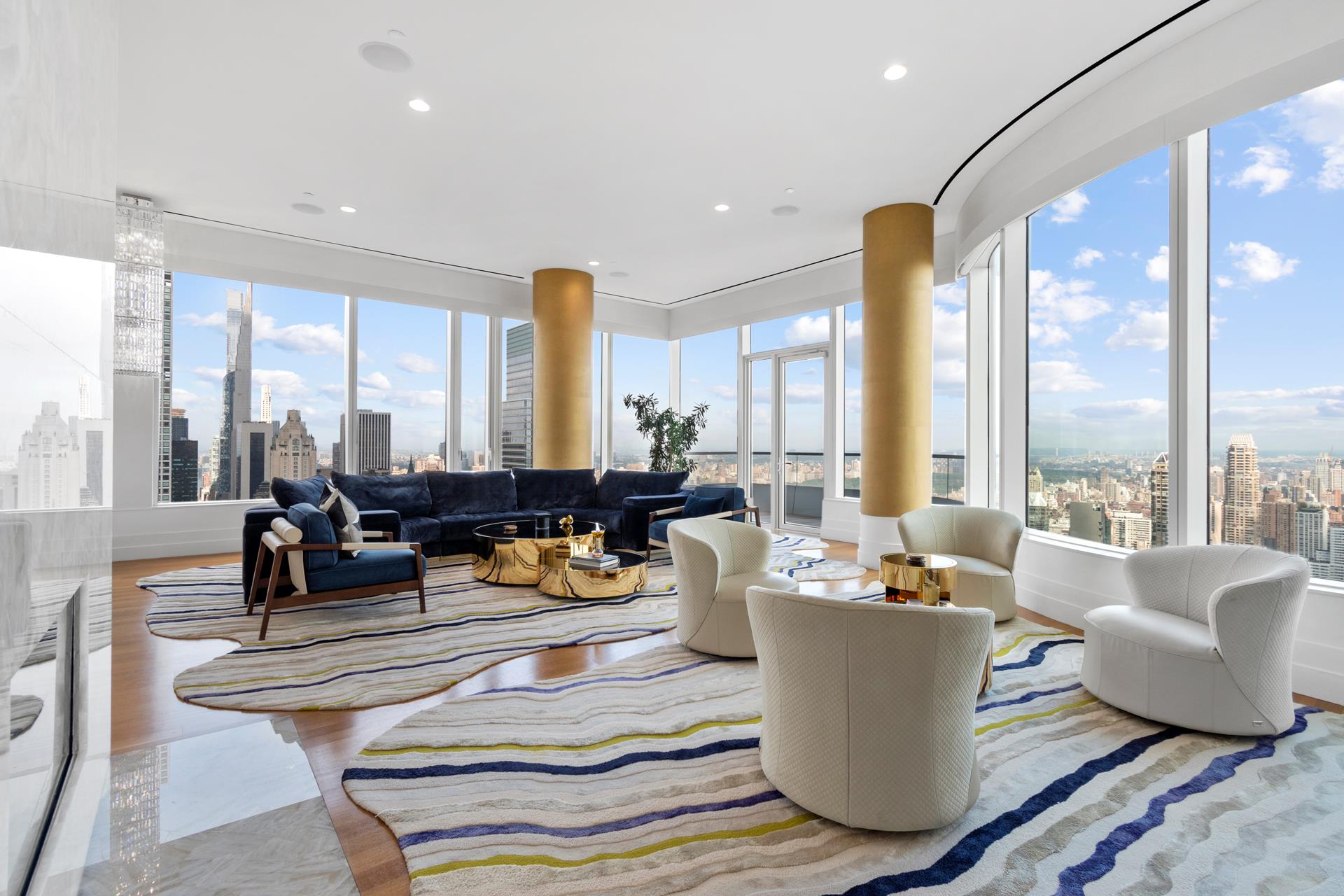 a living room with furniture and large windows