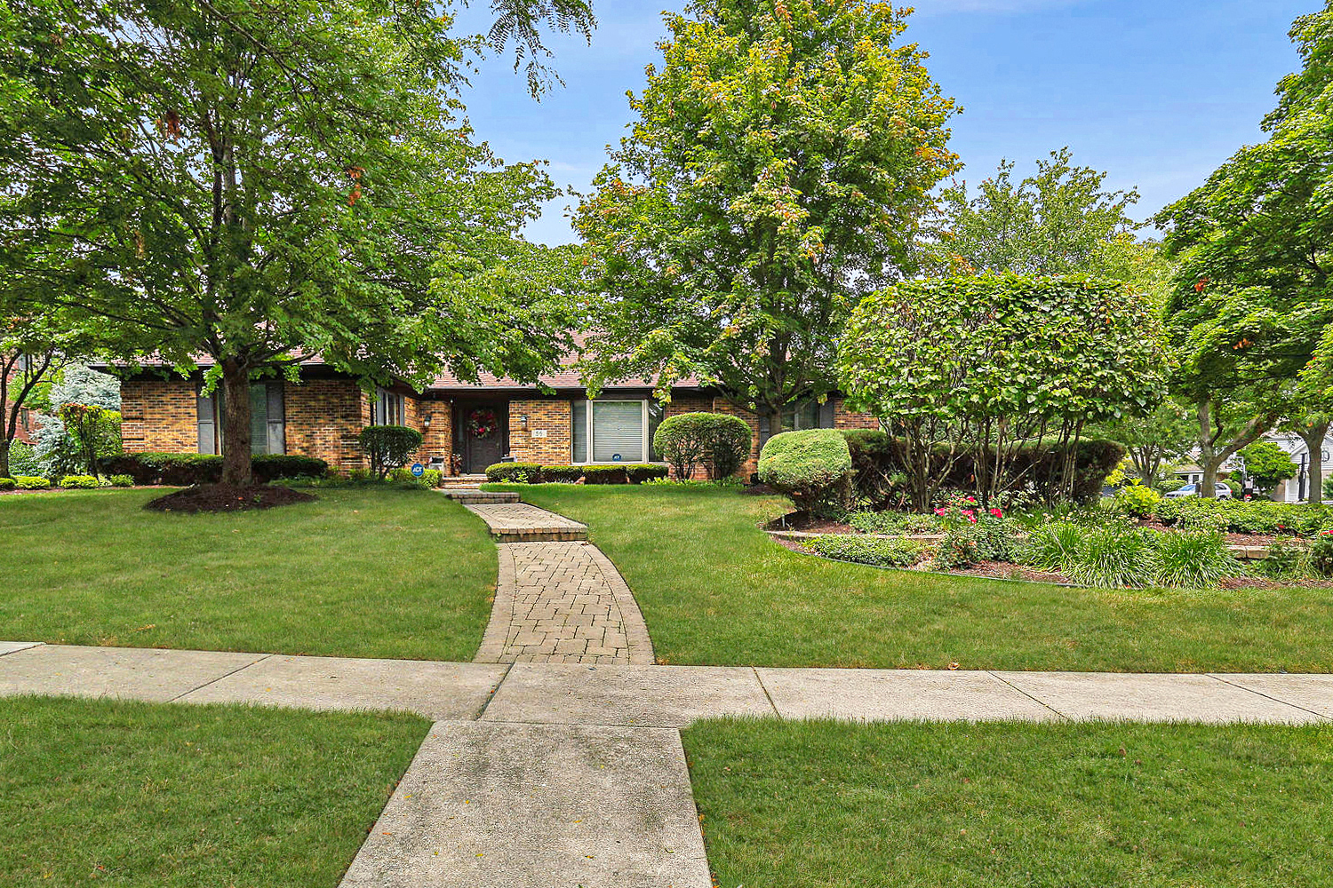 a front view of a house with a garden