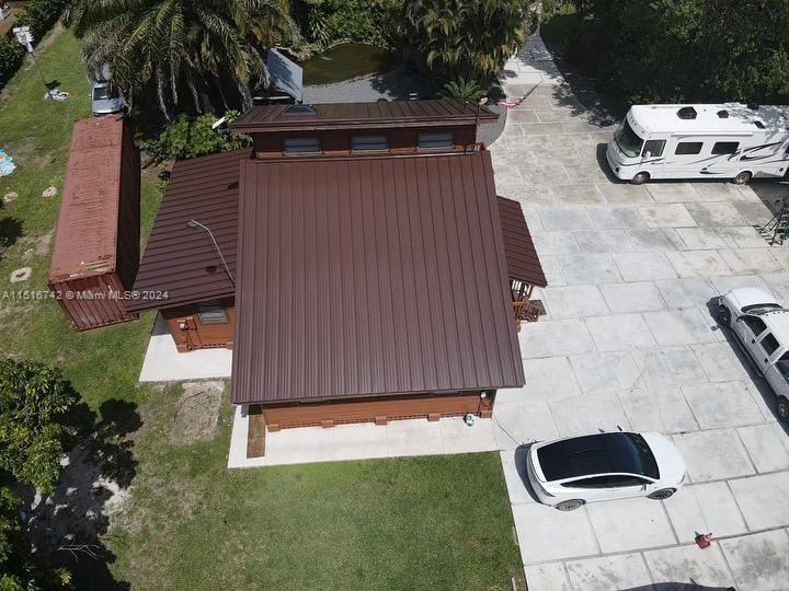 a view of backyard with barbeque grill and potted plants