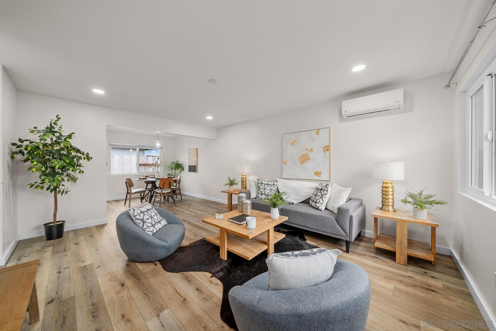 a living room with furniture and a potted plant