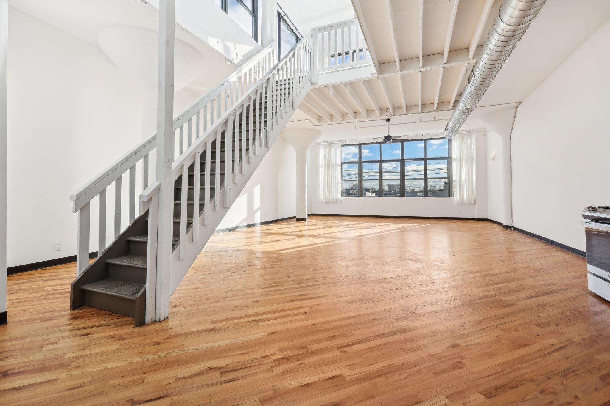 a view of an entryway with wooden floor