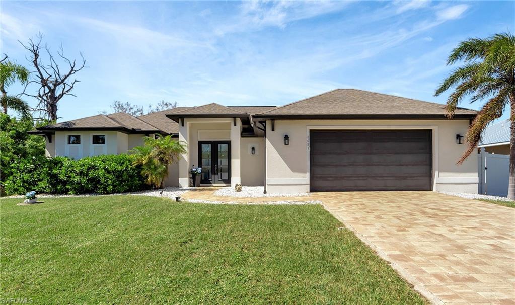 a front view of a house with a yard and garage