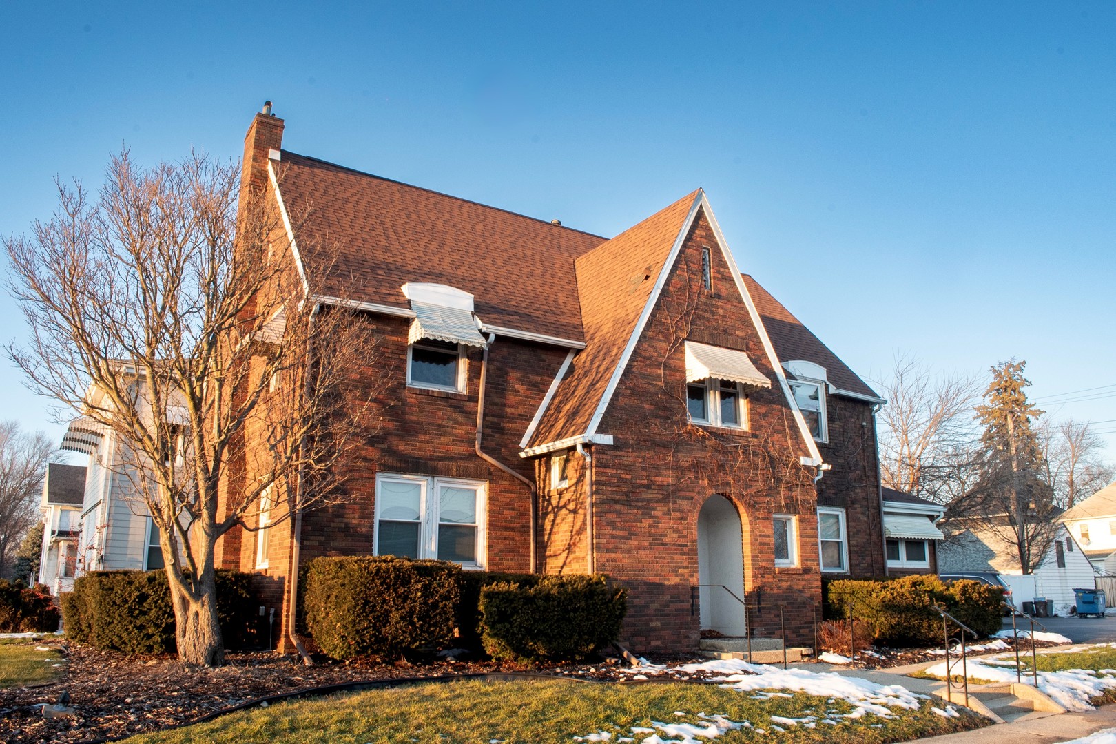 a view of a brick building next to a yard