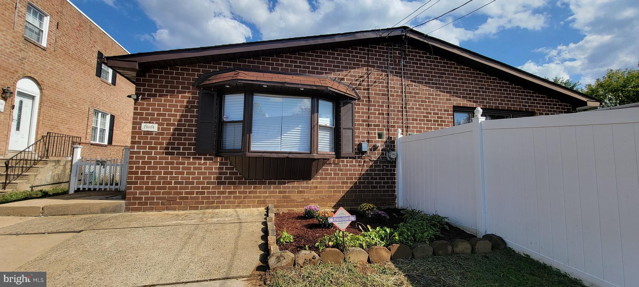 a front view of a house with plants