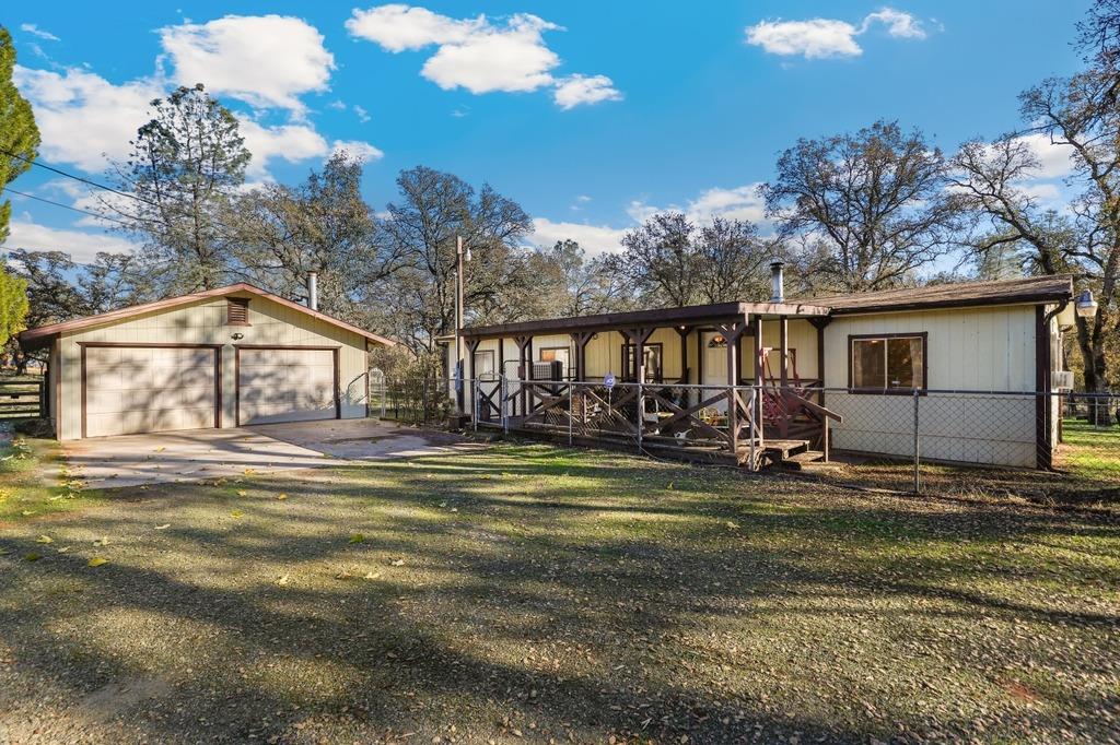 a view of a house with backyard and sitting area