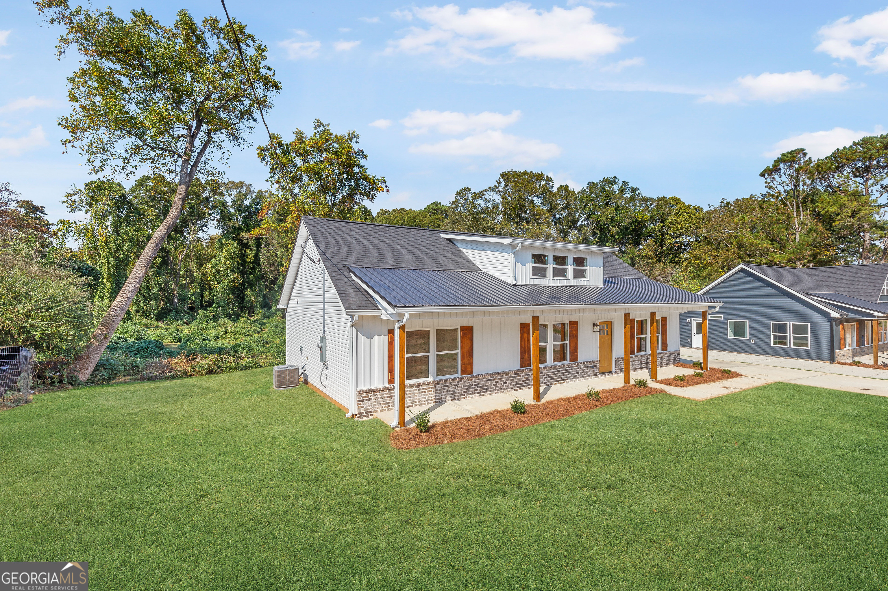 a view of a house with a backyard porch and sitting area