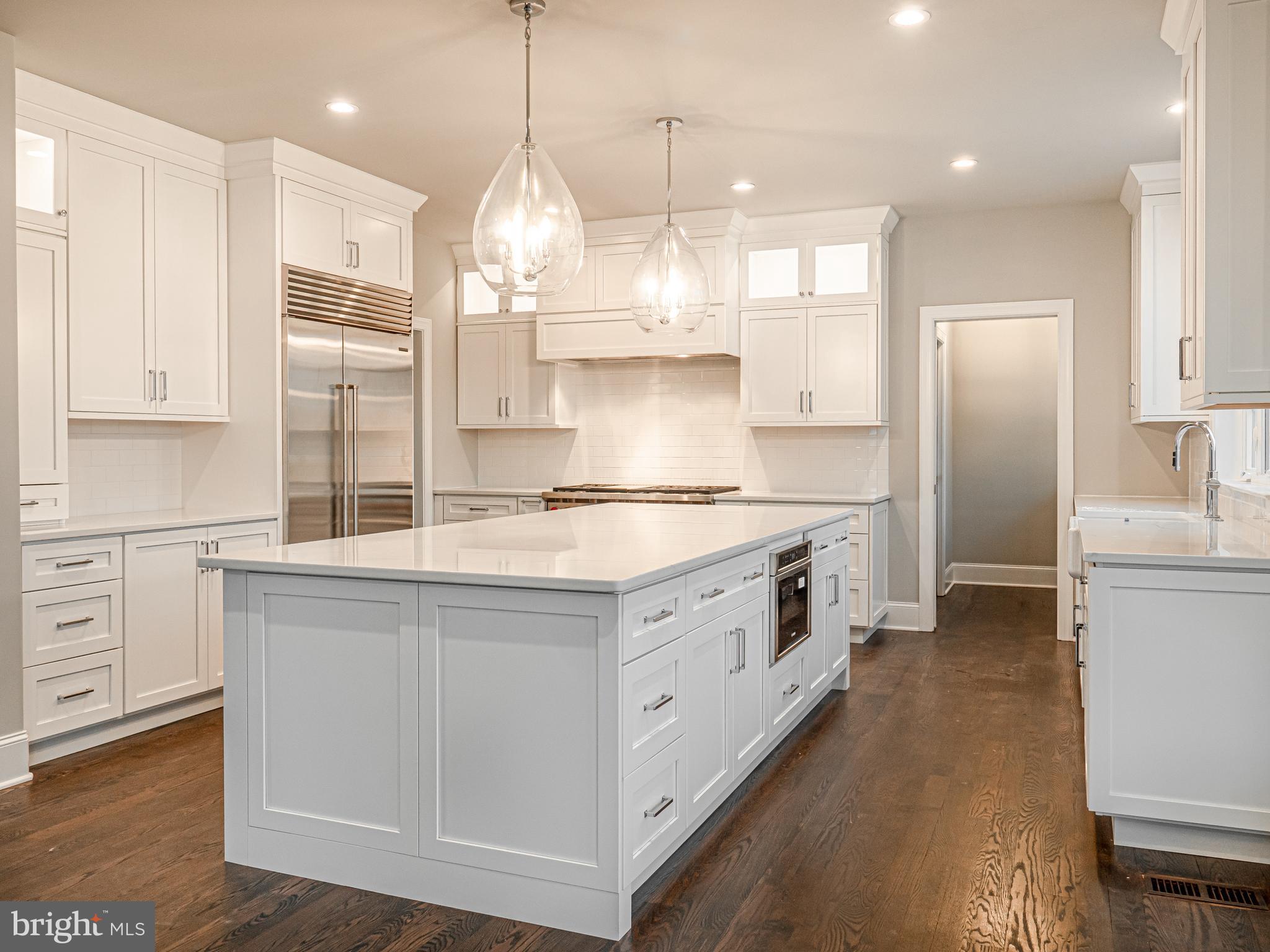 a kitchen with stainless steel appliances granite countertop a sink a stove and a refrigerator