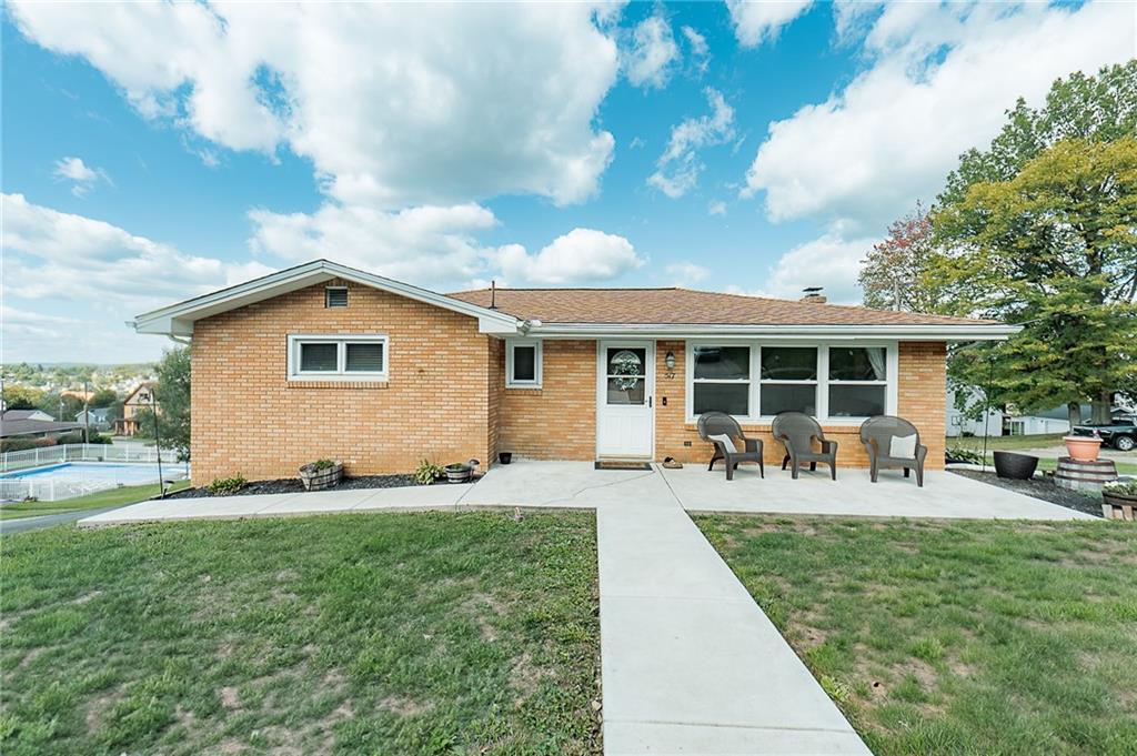 a front view of house with yard and seating space