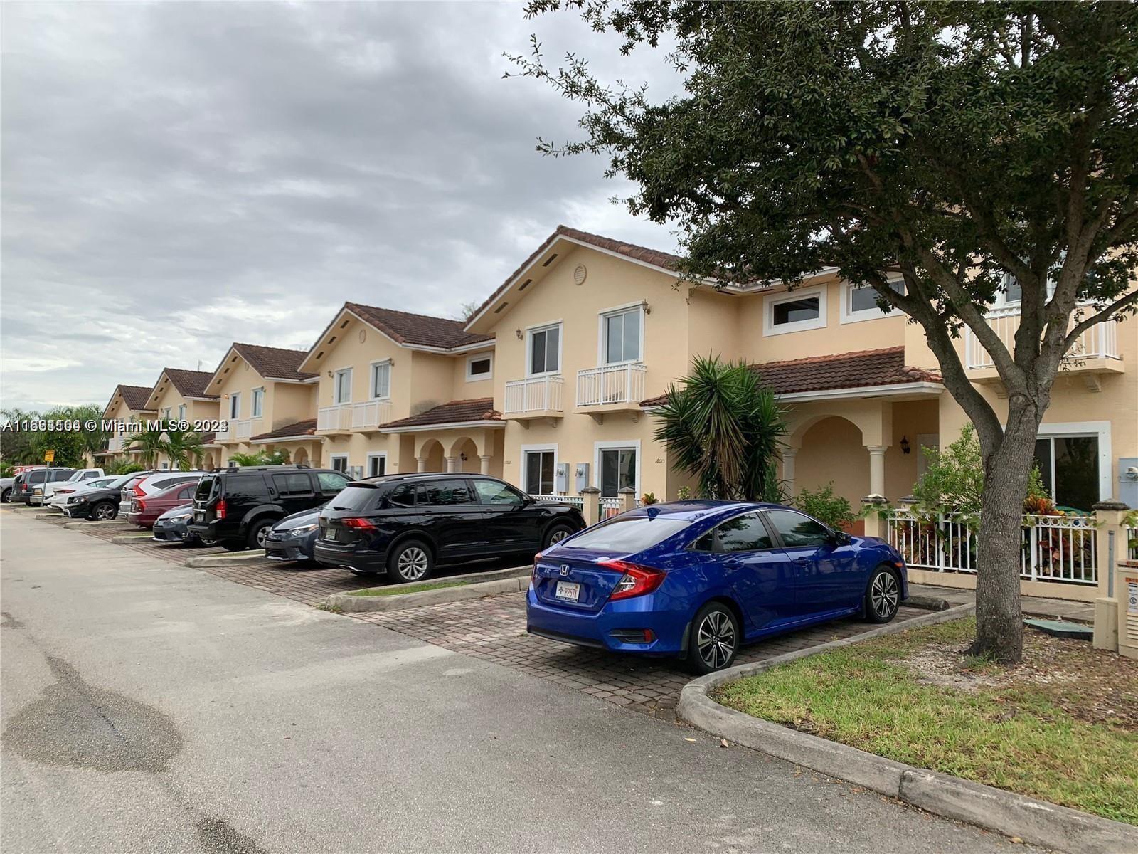 a couple of cars parked in front of a house