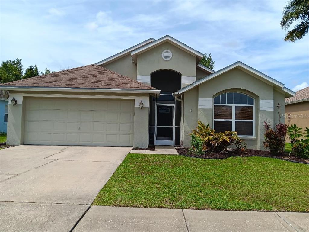 a front view of a house with a garden and yard