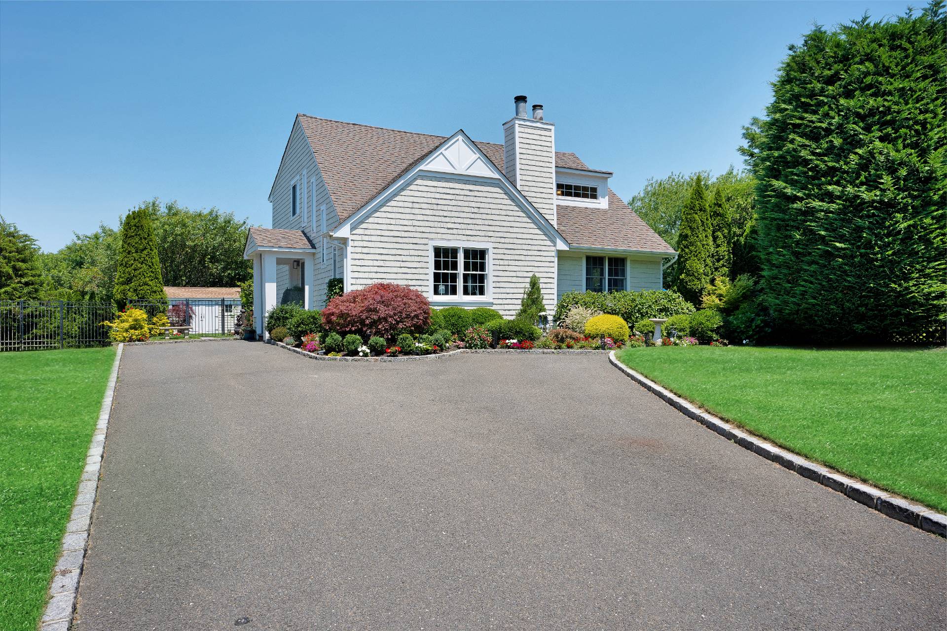 a front view of house with yard and green space