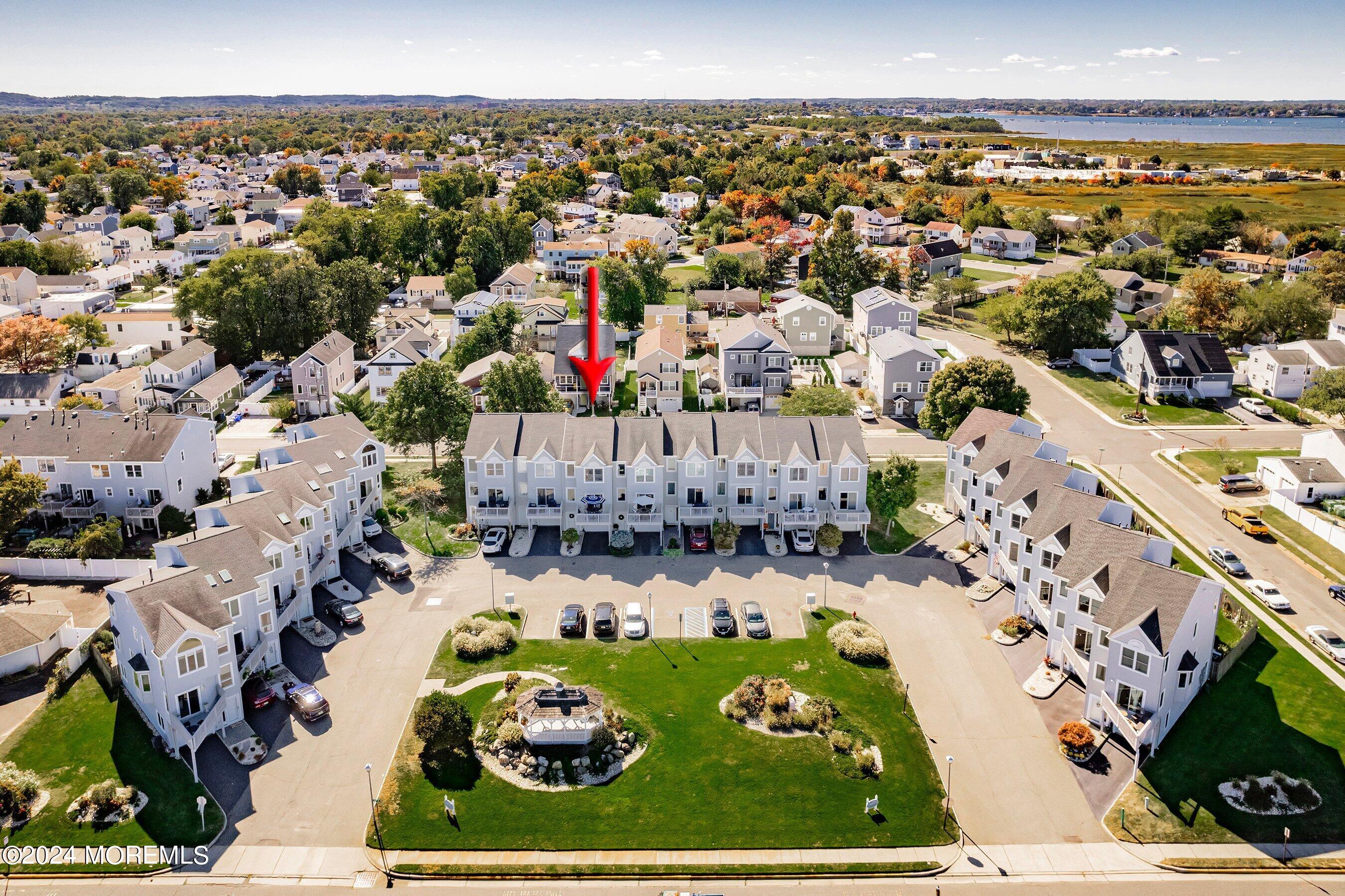 an aerial view of house with yard swimming pool and ocean view