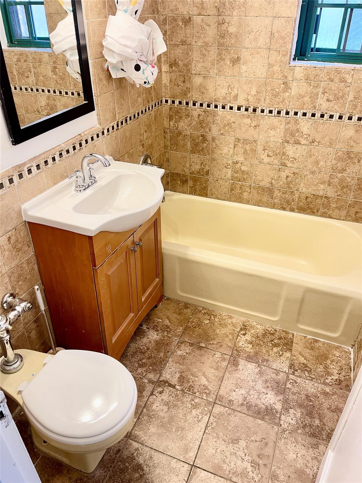 a bathroom with a sink a toilet and bathtub