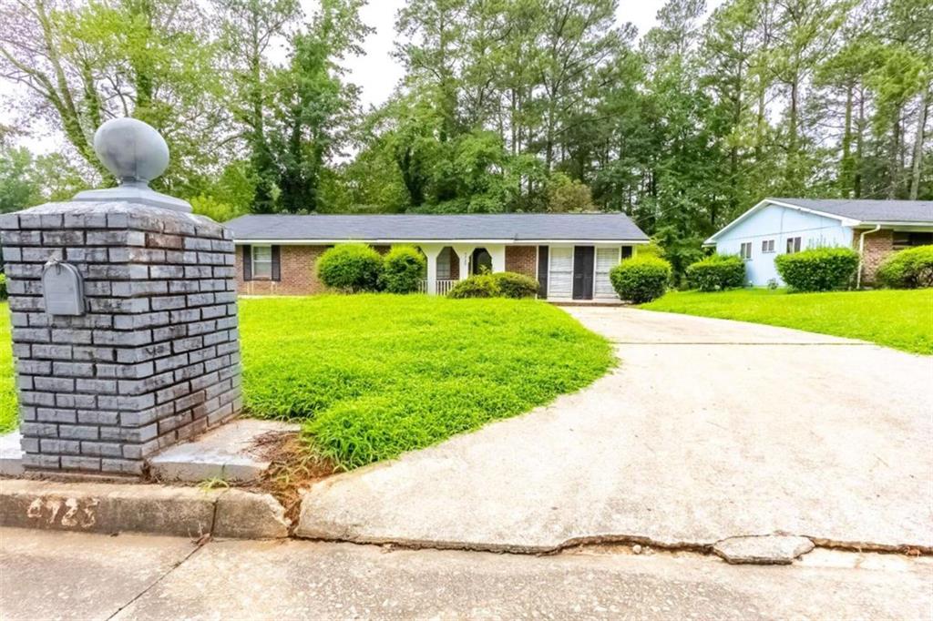 a front view of house with yard and green space