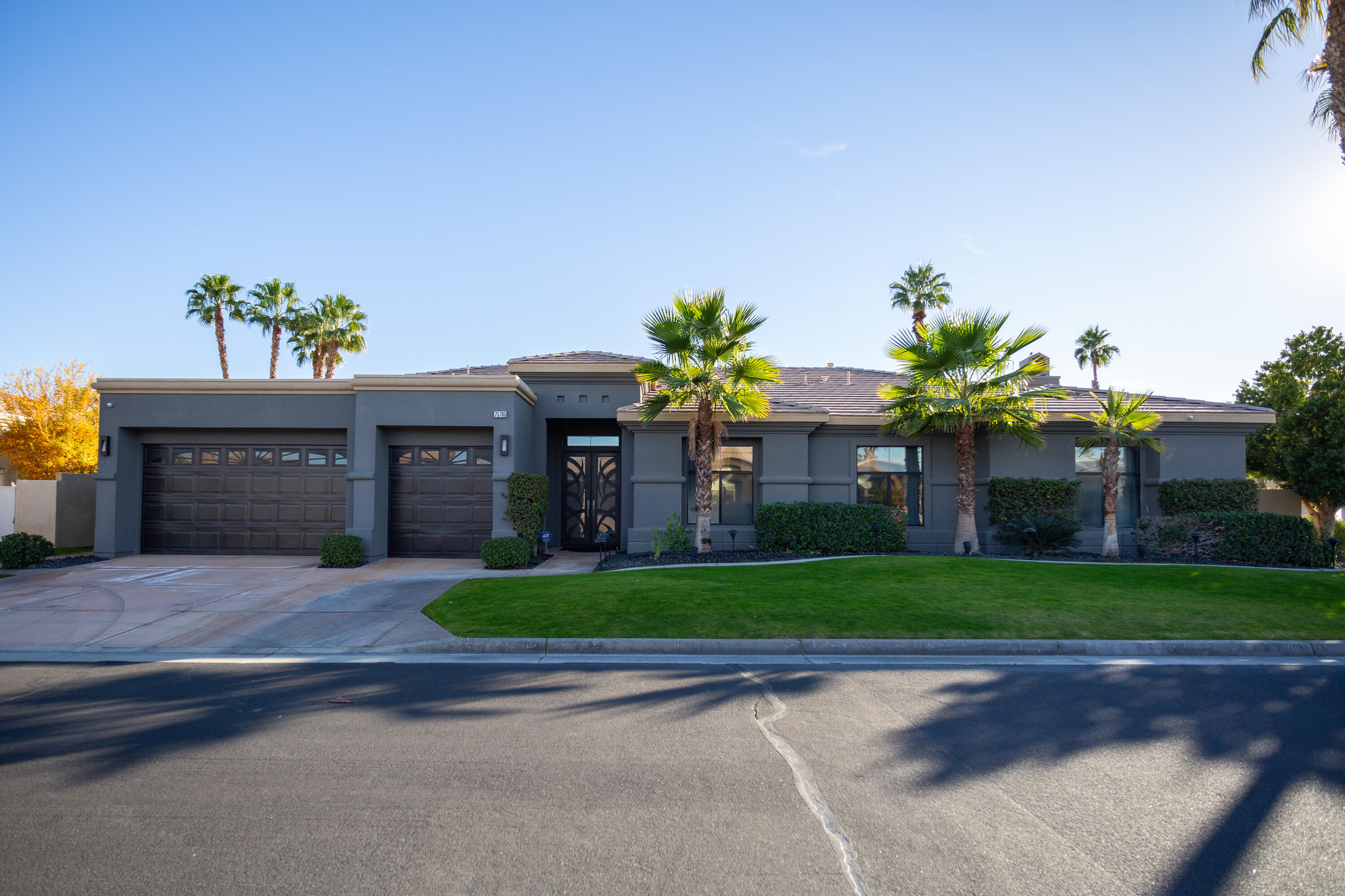 a front view of a house with a yard and a garage