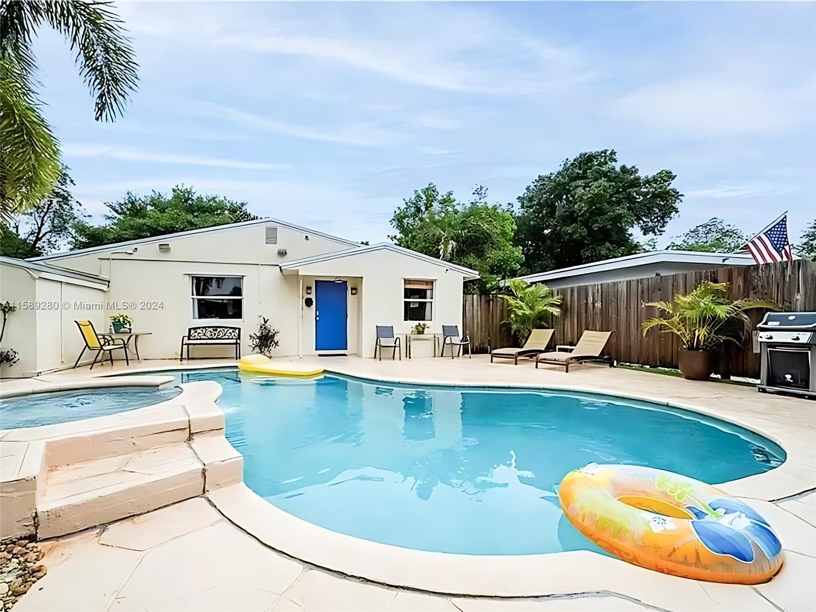 a view of a house with swimming pool and sitting area