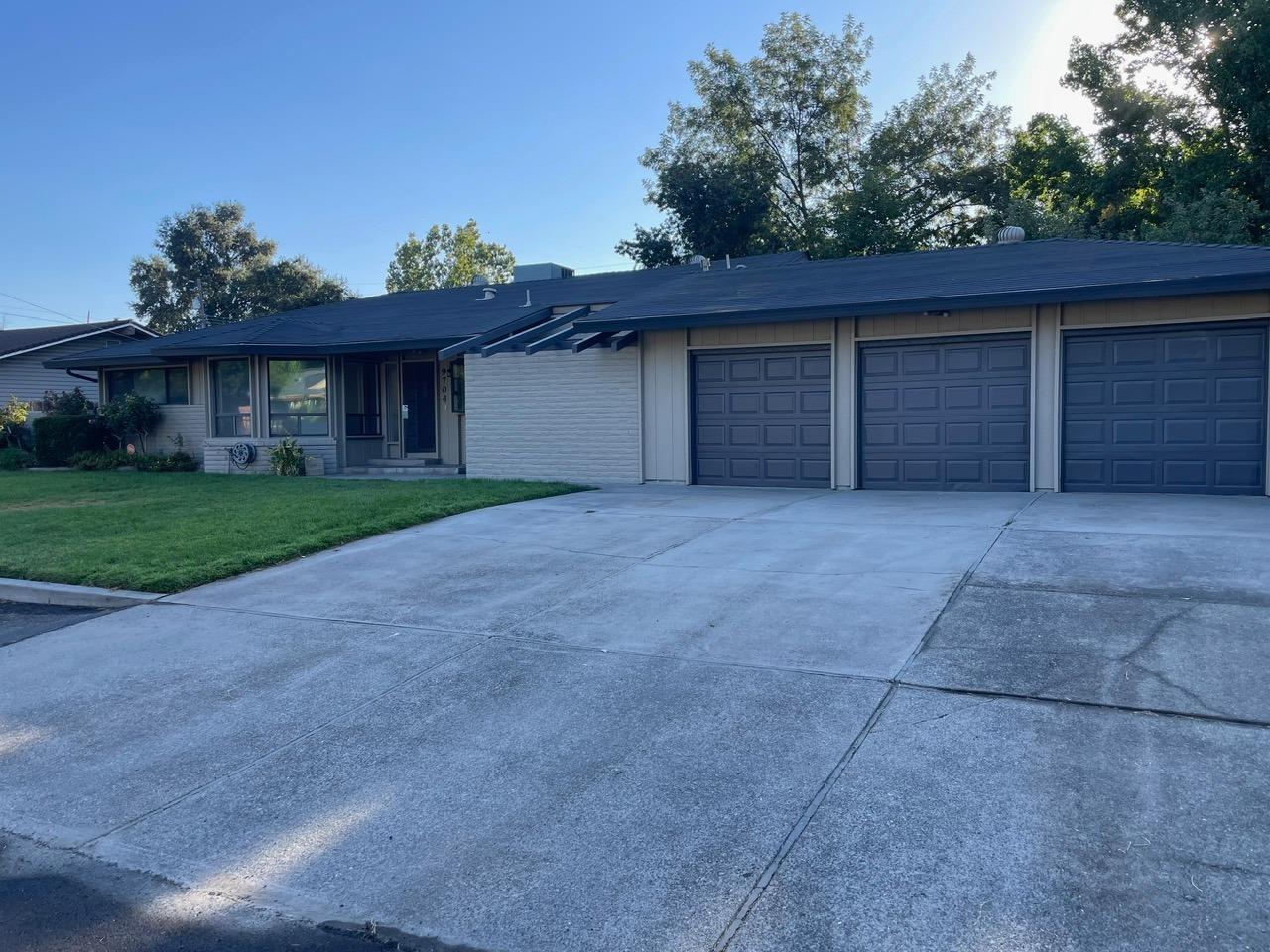 a view of a house with a yard and a garage